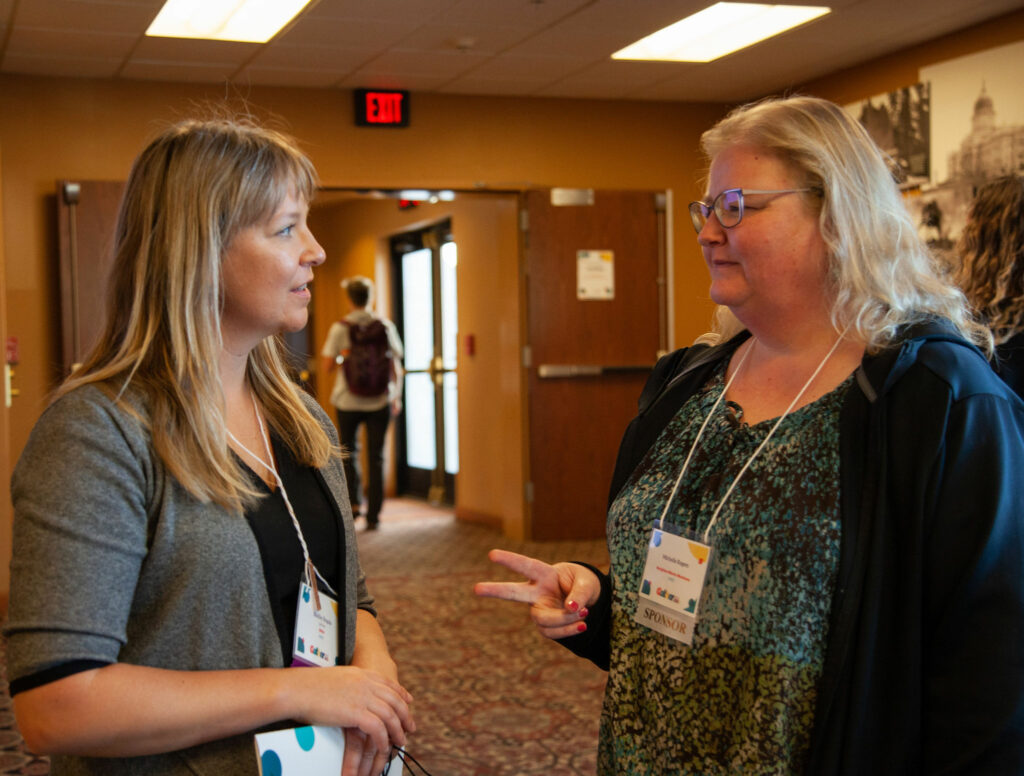 Shelby Rogala converses with a conference attendee.
