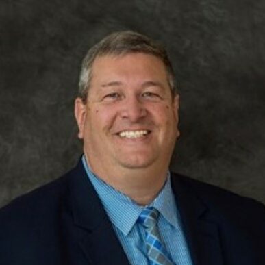 Headshot of MNA board member Ron Slinger in suit and tie.