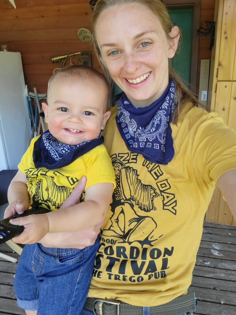 Candid "selfie" of Casey Fuson with her young son, both wearing yellow shirts and blue bandanas.